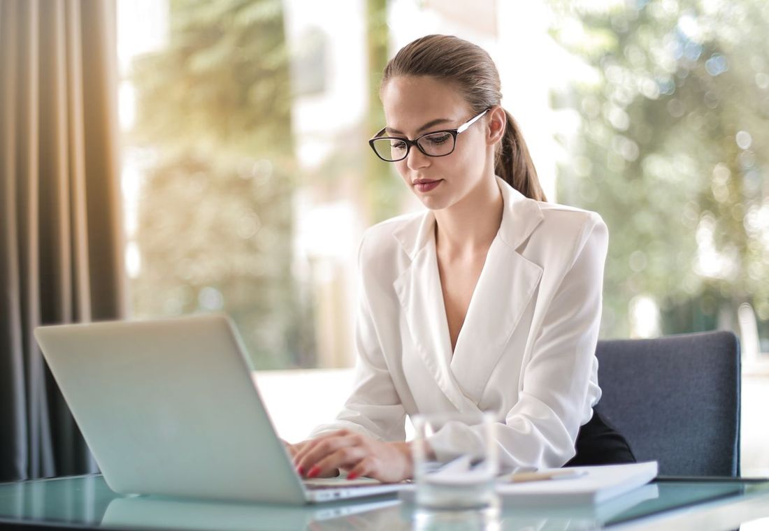 A professional working on a laptop